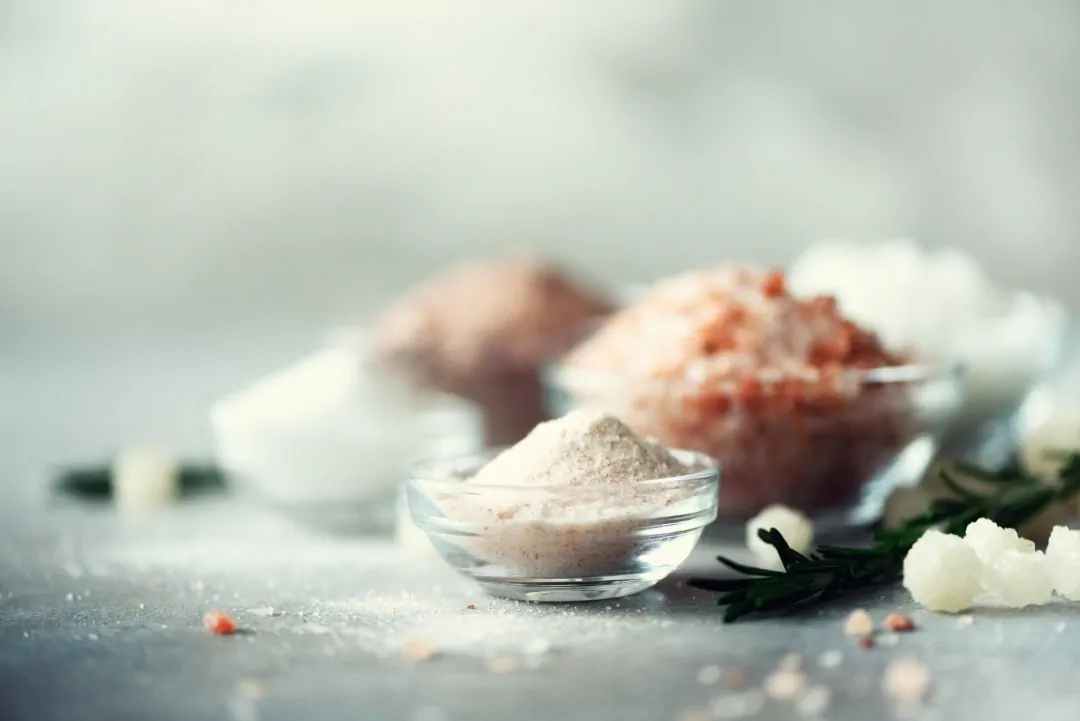 mix of different salt types on grey concrete backg causes of kidney stones